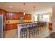 Spacious kitchen with island, granite countertops, stainless appliances, and adjacent dining area at 3755 Sanibel St, Clermont, FL 34711