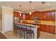 Modern kitchen with stainless steel appliances, dark wood cabinetry and bar-style seating at 3755 Sanibel St, Clermont, FL 34711
