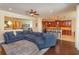 Open-concept living room with a blue sectional sofa and seamless flow into the dining and kitchen areas at 3755 Sanibel St, Clermont, FL 34711