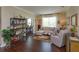Cozy living room with hardwood floors, neutral paint, plenty of natural light and an open doorway to an office at 3755 Sanibel St, Clermont, FL 34711