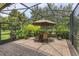Charming screened patio with brick flooring and lush landscaping, perfect for enjoying the outdoors in comfort at 3755 Sanibel St, Clermont, FL 34711