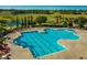 Large community pool with plenty of chairs and umbrellas at 3755 Sanibel St, Clermont, FL 34711