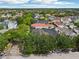 Wide aerial shot showcases a neighborhood with beautiful homes, lush trees and community features at 4001 Corrine Dr, Orlando, FL 32814