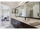 Bathroom featuring a double vanity, and framed mirrors reflecting natural light at 4001 Corrine Dr, Orlando, FL 32814
