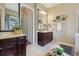 This primary bathroom shows two vanities, decorative metal art, and great tile flooring at 4001 Corrine Dr, Orlando, FL 32814