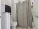 Compact bathroom showcasing a toilet, shower/tub, and linen storage at 4001 Corrine Dr, Orlando, FL 32814