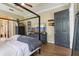 This primary bedroom offers a four poster bed, television, and a gray accent wall at 4001 Corrine Dr, Orlando, FL 32814