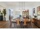 Elegant dining room with modern pendant lighting, stylish decor, and a view into other living spaces at 4001 Corrine Dr, Orlando, FL 32814
