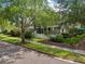 Charming home exterior with manicured lawn, mature trees, and inviting curb appeal at 4001 Corrine Dr, Orlando, FL 32814