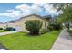 Well-maintained home exterior showcasing a garage, lush lawn, and mature landscaping, perfect for suburban living at 4001 Corrine Dr, Orlando, FL 32814
