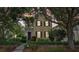 Attractive two-story home with manicured shrubs, brick accent and front porch at 4001 Corrine Dr, Orlando, FL 32814