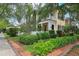 This home boasts a charming balcony, white picket fence, mature landscaping, and well manicured lawn at 4001 Corrine Dr, Orlando, FL 32814