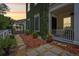 Side view of charming home with climbing vines, stepping stone pathway and outdoor living area at 4001 Corrine Dr, Orlando, FL 32814