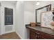 This hallway offers a wooden vanity, large mirror, and decorative art at 4001 Corrine Dr, Orlando, FL 32814