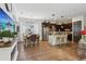 Open concept kitchen with stainless steel appliances, island with seating, and adjacent dining area at 4001 Corrine Dr, Orlando, FL 32814