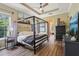 Comfortable main bedroom with tray ceiling, canopy bed, natural light, and modern decor at 4001 Corrine Dr, Orlando, FL 32814