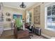 Cozy home office featuring a wooden desk, decorative wall art, and a bright window for natural light at 4001 Corrine Dr, Orlando, FL 32814