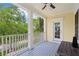 Comfortable porch featuring classic columns, a ceiling fan, and lovely views, ideal for outdoor enjoyment at 4001 Corrine Dr, Orlando, FL 32814