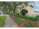 Inviting home featuring lush landscaping, mature trees and a white picket fence that enhances its curb appeal at 4001 Corrine Dr, Orlando, FL 32814