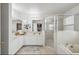 Bright bathroom featuring a soaking tub, a glass shower and dual sinks for added convenience and style at 401 Magpie Ct, Kissimmee, FL 34759