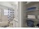 Bright bathroom featuring a shower-tub combo and a linen closet stocked with towels and necessities at 401 Magpie Ct, Kissimmee, FL 34759