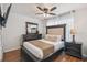 Well-appointed bedroom showcases a queen bed, dark wood furniture, and a neutral color scheme with lots of natural light at 401 Magpie Ct, Kissimmee, FL 34759