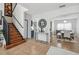Inviting foyer with tile flooring, a wooden staircase, and an open dining area at 401 Magpie Ct, Kissimmee, FL 34759