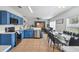 Modern kitchen with blue cabinets, stainless steel appliances, and an adjacent dining area at 401 Magpie Ct, Kissimmee, FL 34759