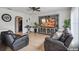 Comfortable living room with tile floors, neutral walls, and a large entertainment center at 401 Magpie Ct, Kissimmee, FL 34759