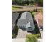 Birds eye view of a charming gray home with a dark roof, manicured lawn and brick driveway at 406 Alcove Dr, Groveland, FL 34736