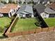 Aerial view of a home with a fenced backyard, manicured lawn, and a screened-in porch in a residential neighborhood at 406 Alcove Dr, Groveland, FL 34736