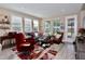 Cozy living room with large windows, stylish furniture, and a vibrant rug creating a welcoming atmosphere at 406 Alcove Dr, Groveland, FL 34736