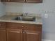 This kitchenette offers a single sink beneath wooden cabinets, perfect for compact meal prep at 4061 Kirkland Blvd, Orlando, FL 32811