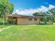 Backyard of a home featuring a shed, wooden patio, and lots of green grass at 4432 Freedom Rd, Kissimmee, FL 34746