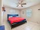 Cozy bedroom with tiled floors, ceiling fan, and dual windows for natural light at 4432 Freedom Rd, Kissimmee, FL 34746