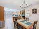 Dining area open to the kitchen features tile floors and a chandelier at 4432 Freedom Rd, Kissimmee, FL 34746