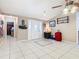 Bright foyer featuring tile flooring, a ceiling fan, and a front door with glass detailing at 4432 Freedom Rd, Kissimmee, FL 34746