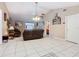 Spacious living room with tile flooring, vaulted ceilings, a ceiling fan, and access to other rooms at 4432 Freedom Rd, Kissimmee, FL 34746