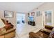 Bright living room with tile flooring, comfortable seating, and vaulted ceiling at 4432 Freedom Rd, Kissimmee, FL 34746