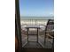 Balcony showcases chairs and a small table, offering stunning ocean views for relaxation at 4453 S Atlantic Ave # 602, Ponce Inlet, FL 32127