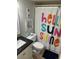 Bathroom with tub/shower, tile floor, and 