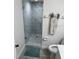 Bathroom featuring a glass door shower, modern tiling, and a decorative starfish towel adding character at 4453 S Atlantic Ave # 602, Ponce Inlet, FL 32127