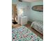 Bright guest bedroom with two twin beds, a surfboard decoration, and access to the ensuite bathroom at 4453 S Atlantic Ave # 602, Ponce Inlet, FL 32127
