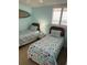 Bright guest bedroom with two twin beds, ocean view, and a surfboard decoration at 4453 S Atlantic Ave # 602, Ponce Inlet, FL 32127