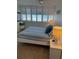 Comfortable bedroom features white nightstands, lamps, blue bedding, and window shutters, offering bright natural light at 4453 S Atlantic Ave # 602, Ponce Inlet, FL 32127