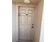Neutral-toned front door with a small window and door number; clean, simple, and well-maintained appearance at 4453 S Atlantic Ave # 602, Ponce Inlet, FL 32127