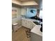 Kitchen and living space with white cabinets and stainless steel appliances with an ocean view at 4453 S Atlantic Ave # 602, Ponce Inlet, FL 32127