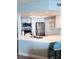 Bright kitchen features white cabinets, stainless steel appliances, and a breakfast bar with seating at 4453 S Atlantic Ave # 602, Ponce Inlet, FL 32127