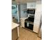 Compact kitchen featuring stainless steel appliances and white cabinetry at 4453 S Atlantic Ave # 602, Ponce Inlet, FL 32127