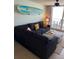 Comfortable living room with a large, inviting sofa, and a surfboard on the wall as decor at 4453 S Atlantic Ave # 602, Ponce Inlet, FL 32127